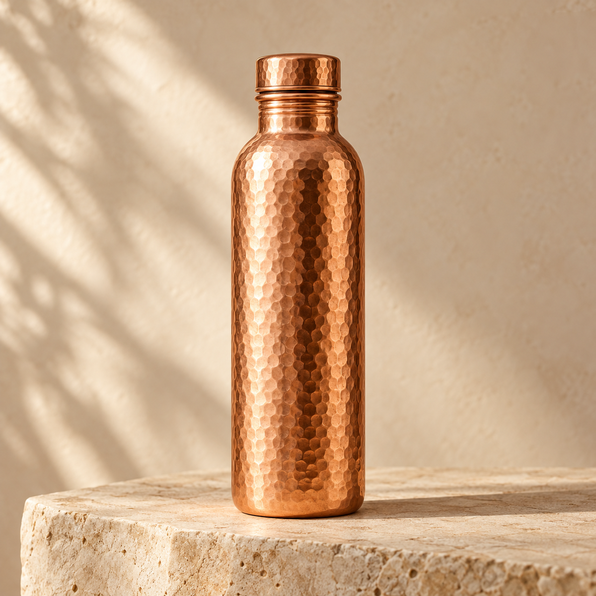 KindCopper concept image of a hammered copper water bottle on limestone